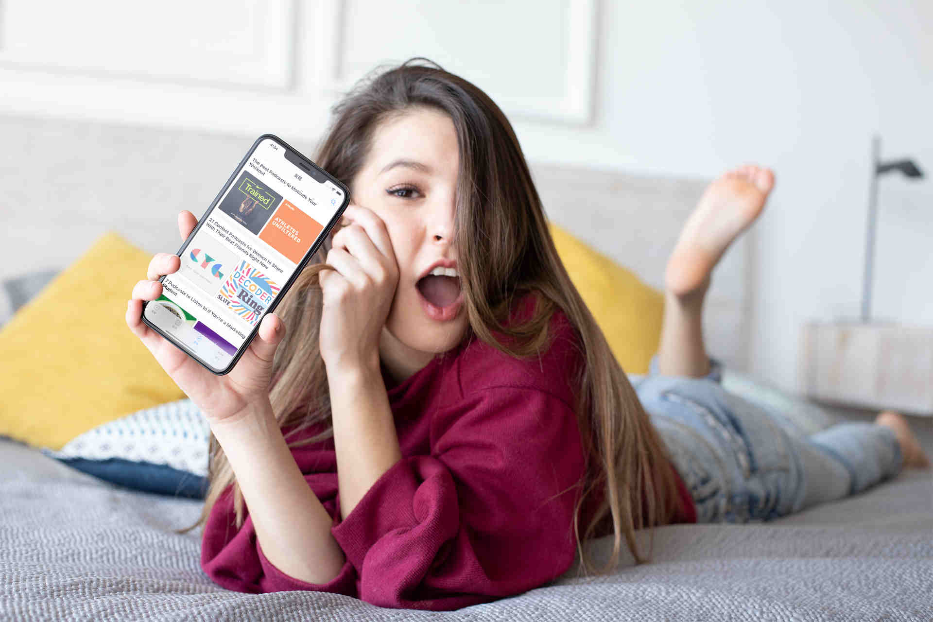 Woman holding an iPhone x with the PA set alarm screen visible